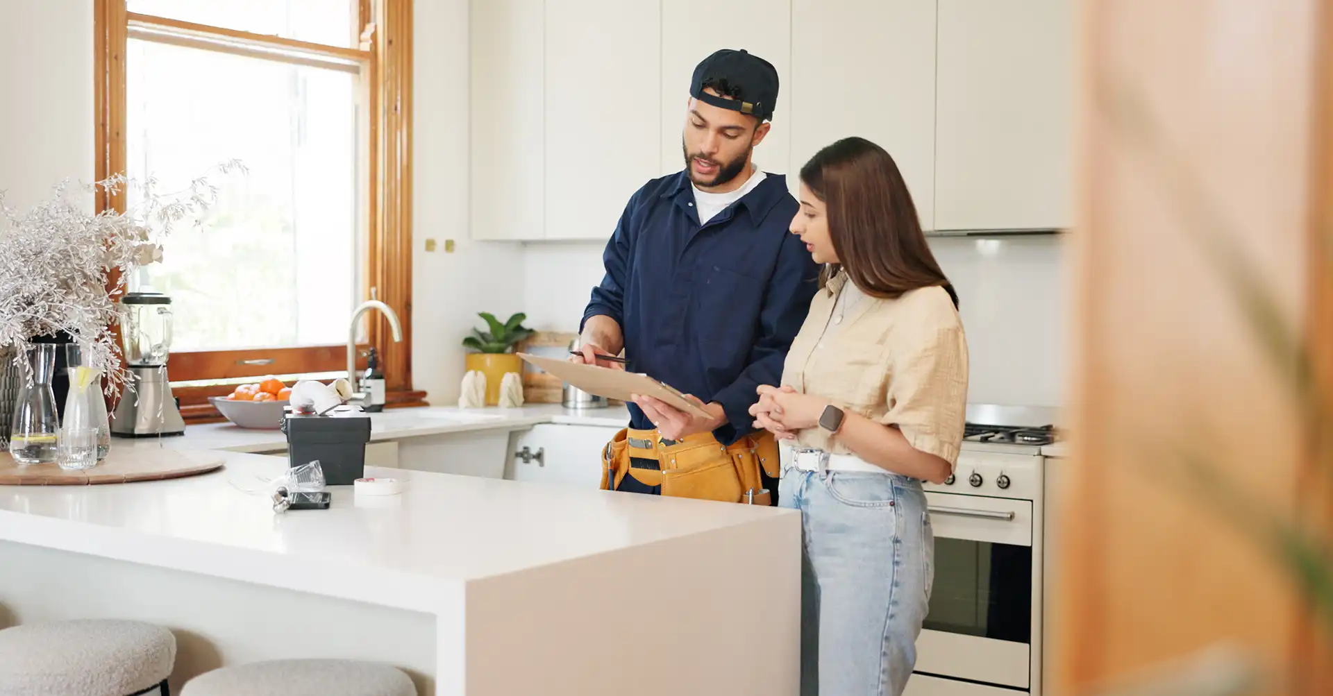 plumber and home owner in denham springs discussing kitchen plumbing