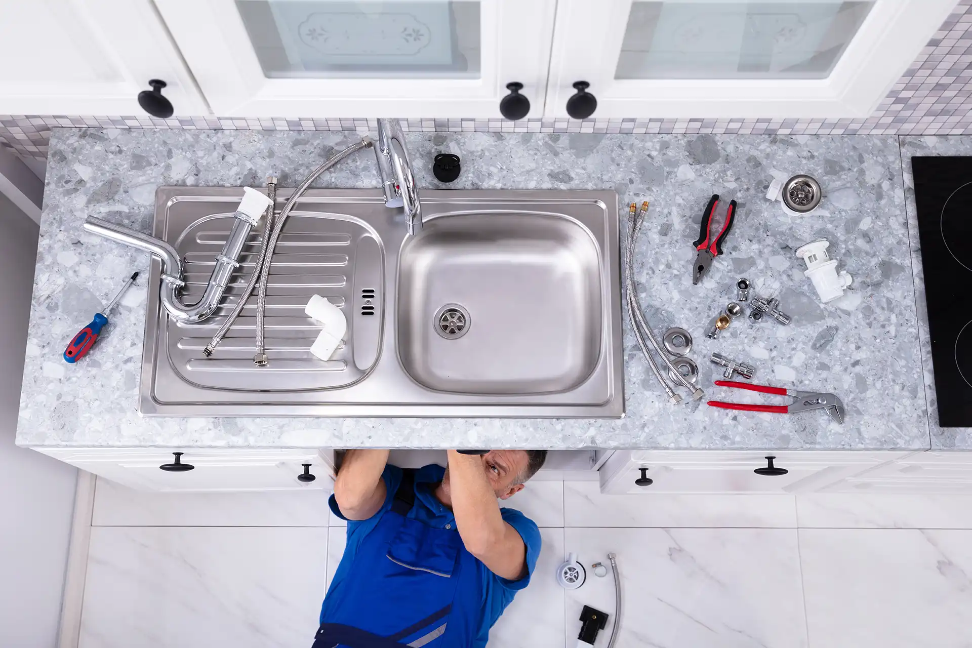 plumber working on kitchen sink